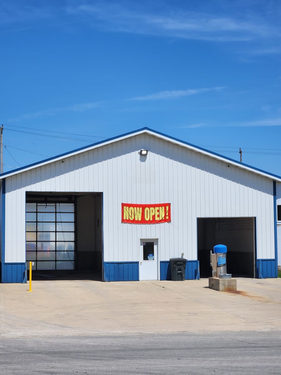 A large, white and blue industrial building with a 