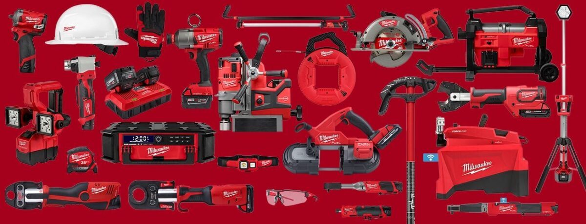 A collection of Milwaukee power tools and accessories displayed against a red background. Items include a hard hat, battery packs, drills, saws, a lighting tool, a speaker, and various other cordless and handheld power tools, all predominantly in red and black.