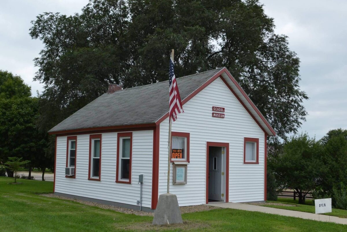 A small white building with red trim, labeled as 